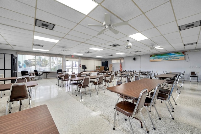 dining space featuring speckled floor, a paneled ceiling, and visible vents