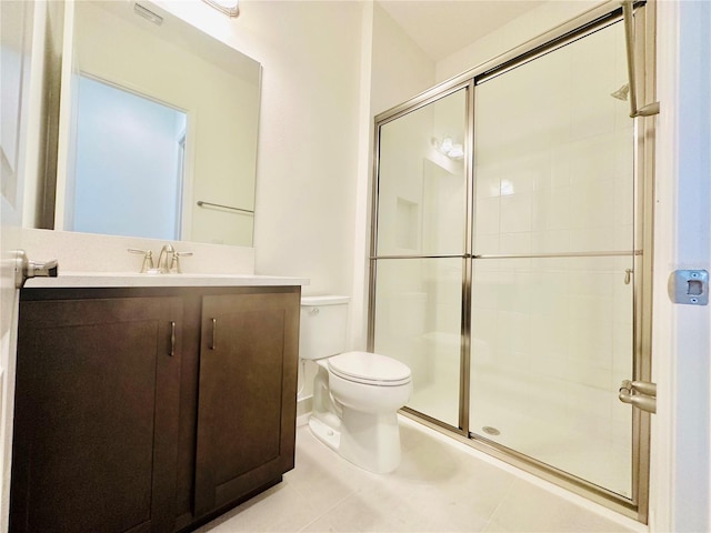 bathroom with toilet, a shower stall, tile patterned flooring, and vanity