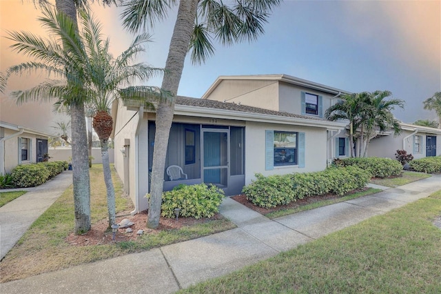 view of front of property featuring a front lawn and stucco siding