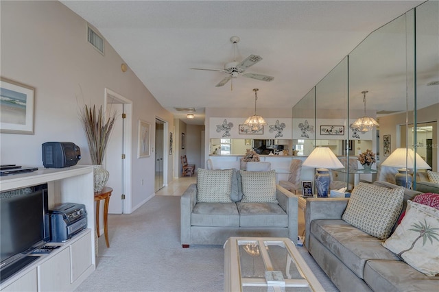 living room with light carpet, visible vents, and ceiling fan with notable chandelier