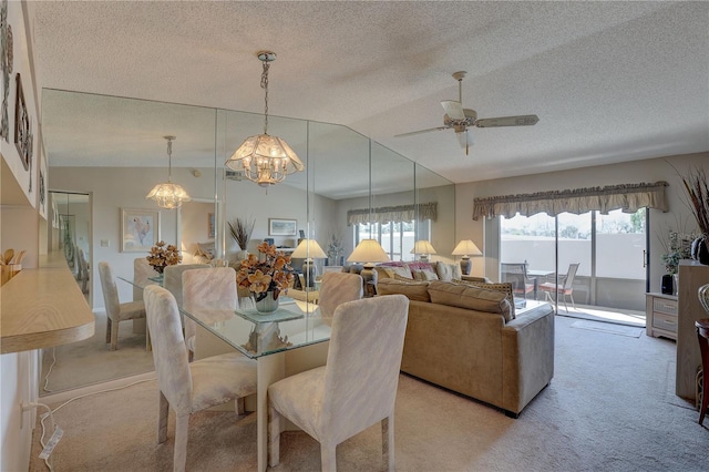 dining room with ceiling fan, vaulted ceiling, a textured ceiling, and light colored carpet