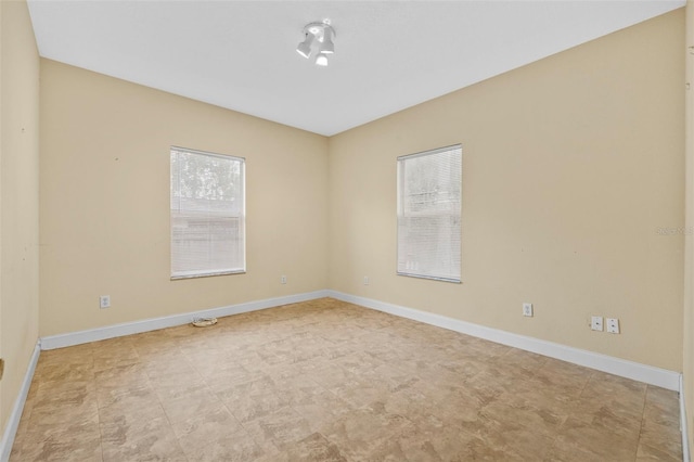 spare room with baseboards