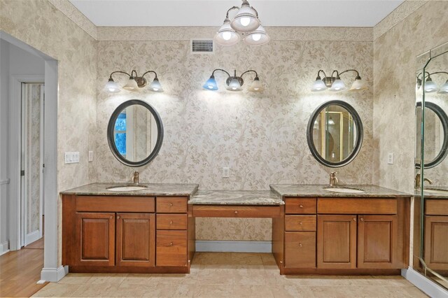 bathroom with two vanities, visible vents, and a sink