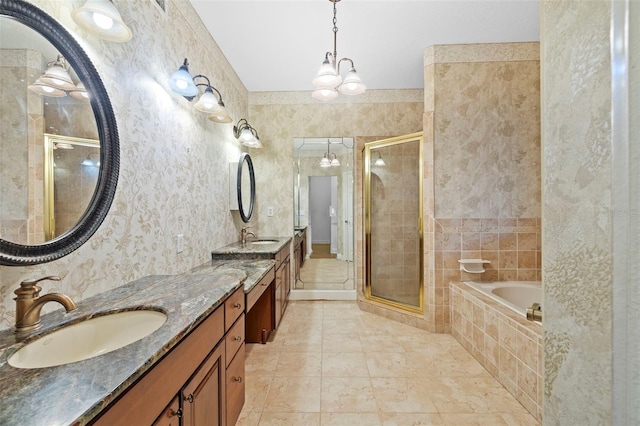 bathroom featuring double vanity, a garden tub, a shower stall, and a sink