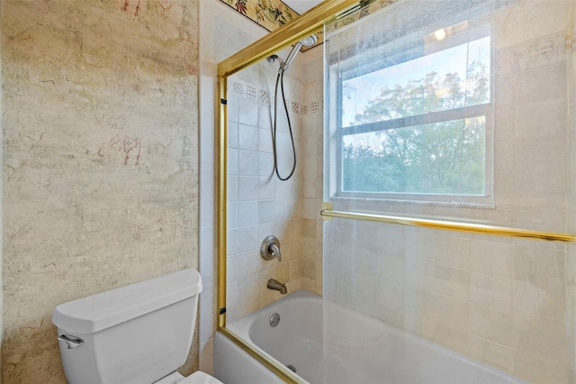 bathroom with toilet and bathing tub / shower combination