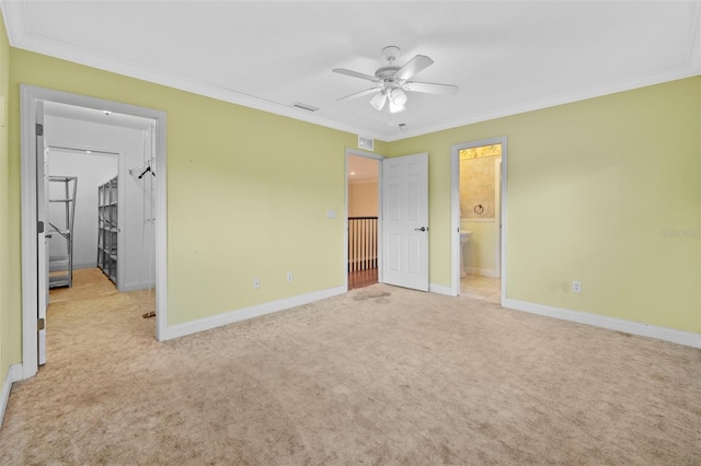 unfurnished bedroom with carpet floors, visible vents, ornamental molding, and baseboards