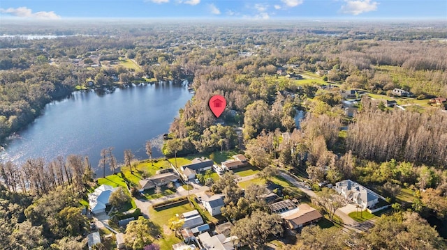 aerial view with a water view and a forest view