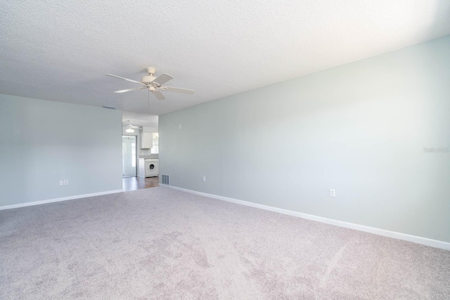 empty room featuring ceiling fan, a textured ceiling, baseboards, and carpet flooring