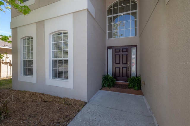 doorway to property with stucco siding