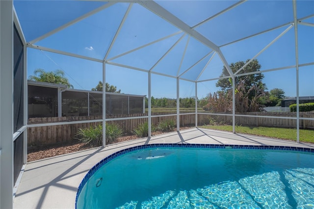 view of pool featuring a lanai, a patio area, fence, and a fenced in pool