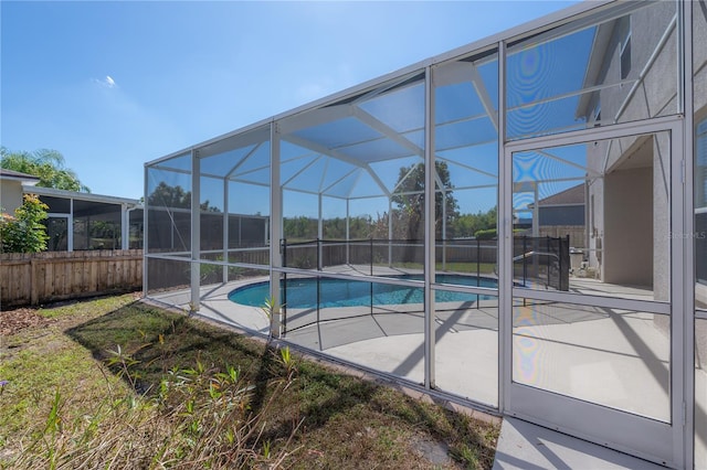 view of pool with a lanai, fence, a fenced in pool, and a patio