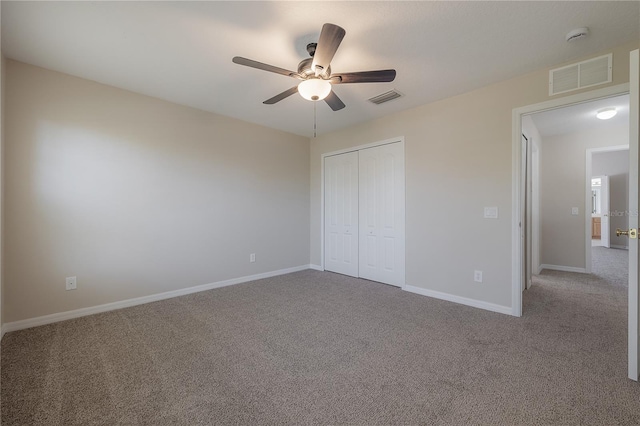 unfurnished bedroom featuring a closet, carpet flooring, and visible vents