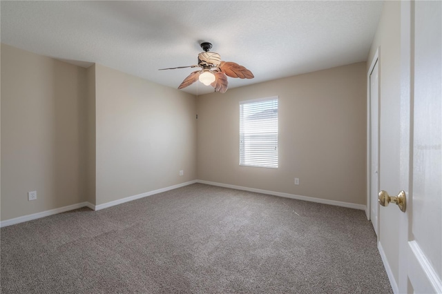 unfurnished room featuring carpet floors, ceiling fan, baseboards, and a textured ceiling