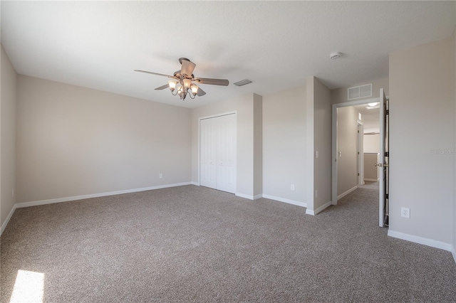 unfurnished bedroom featuring a closet, visible vents, and carpet flooring