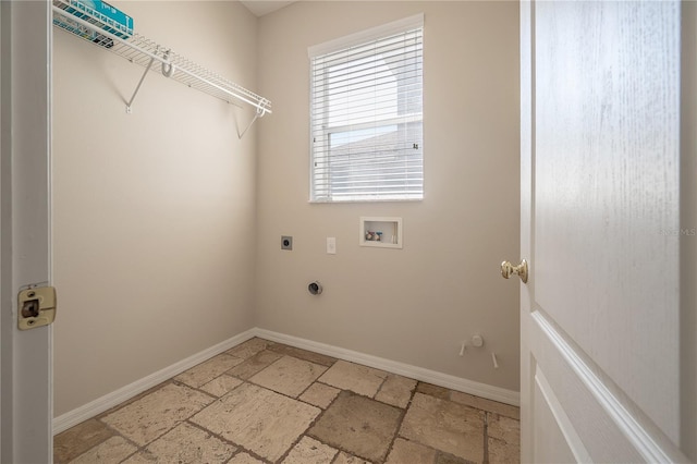 clothes washing area with hookup for a washing machine, laundry area, baseboards, electric dryer hookup, and stone tile flooring