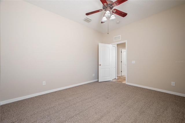 unfurnished room featuring light carpet, ceiling fan, visible vents, and baseboards