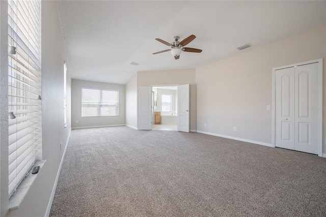 interior space with ceiling fan, carpet floors, visible vents, and baseboards