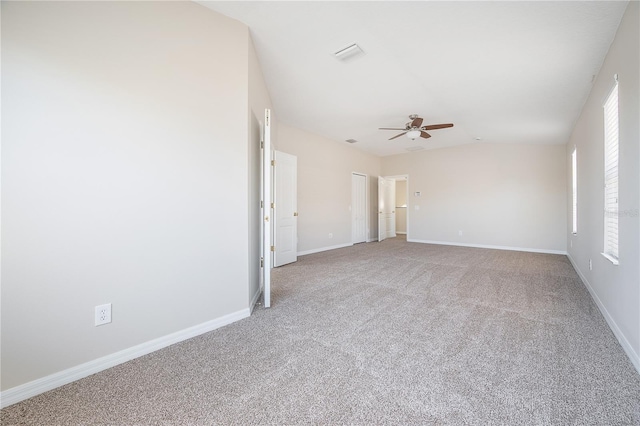 empty room featuring plenty of natural light, visible vents, baseboards, and carpet flooring