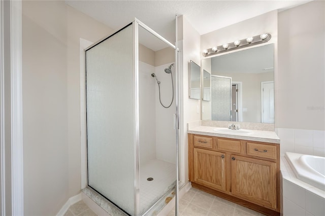 full bathroom with a stall shower, vanity, a bath, and tile patterned floors