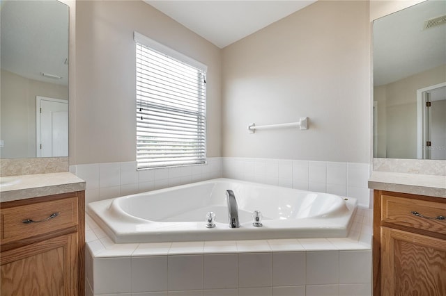 full bathroom with a garden tub, visible vents, and vanity