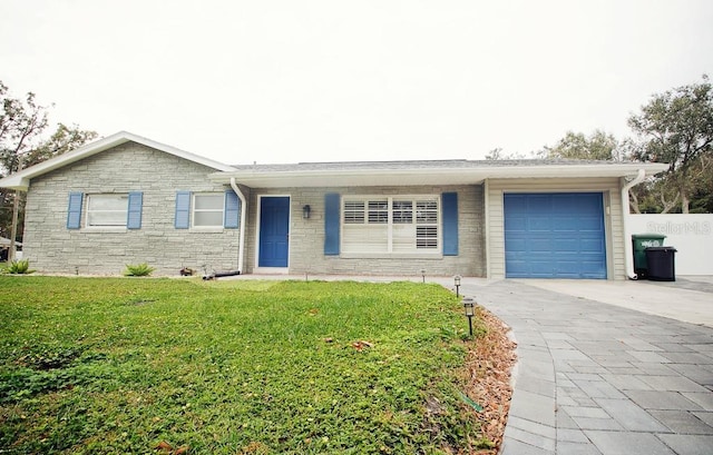 single story home featuring an attached garage, stone siding, a front lawn, and concrete driveway