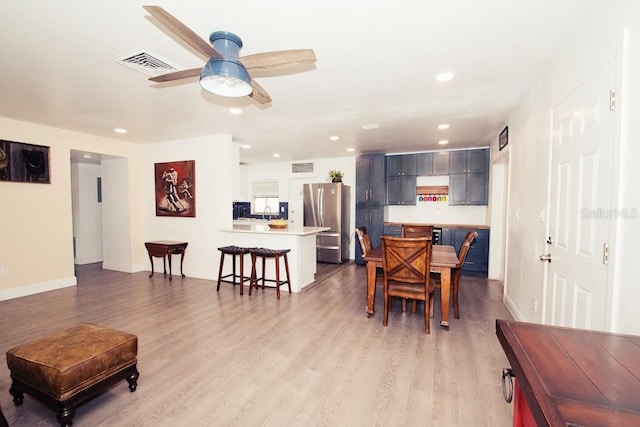 dining room featuring light wood-style floors, recessed lighting, visible vents, and a ceiling fan