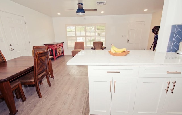 kitchen featuring recessed lighting, light countertops, visible vents, light wood-style floors, and white cabinetry