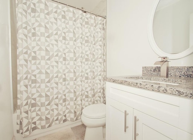 bathroom featuring toilet, curtained shower, and vanity