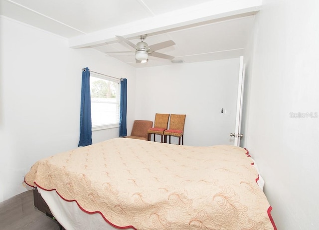 bedroom with beam ceiling and a ceiling fan