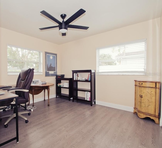 office area with ceiling fan, baseboards, and wood finished floors