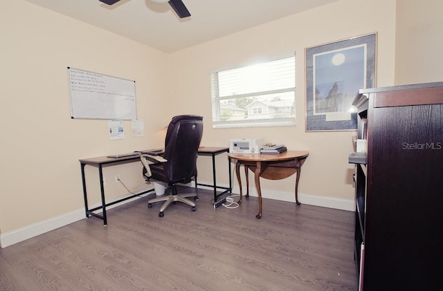 office area with a ceiling fan, baseboards, and wood finished floors