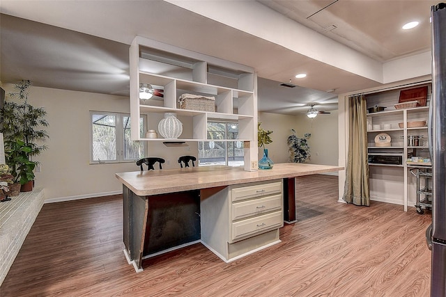 office featuring ceiling fan, recessed lighting, wood finished floors, visible vents, and baseboards