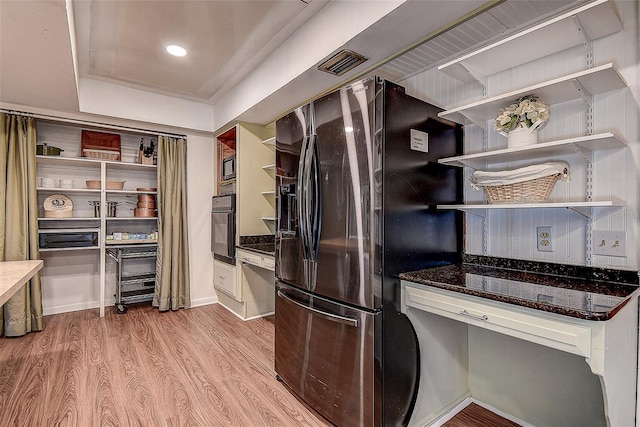 kitchen featuring open shelves, visible vents, dark stone countertops, wood finished floors, and black appliances