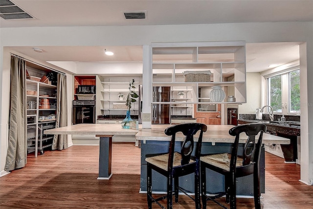 dining space featuring dark wood-style flooring and visible vents