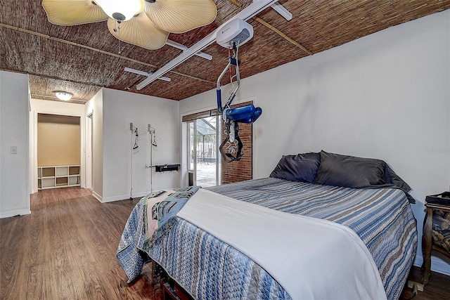 bedroom with wood finished floors and baseboards