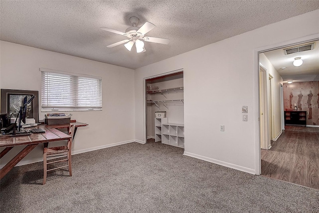 home office featuring a ceiling fan, carpet, visible vents, and baseboards