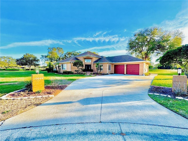 prairie-style house with a garage, a front yard, and driveway