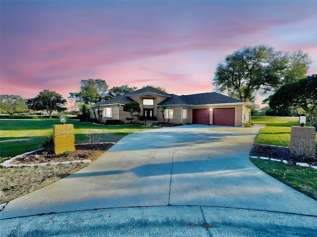 view of front of house with driveway, a garage, and a front yard