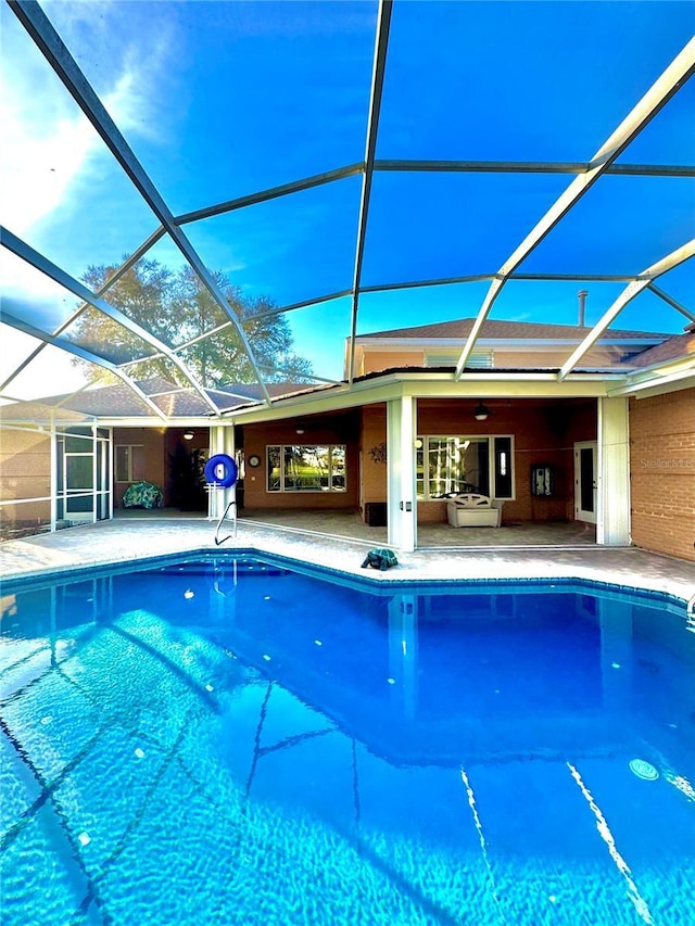 pool featuring a lanai and a patio