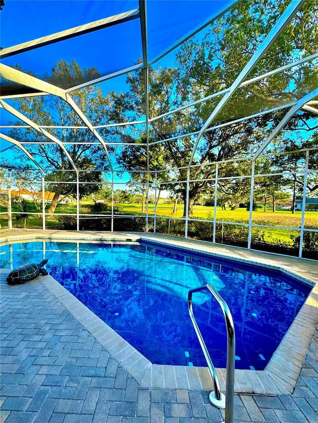 pool featuring a lanai and a patio area