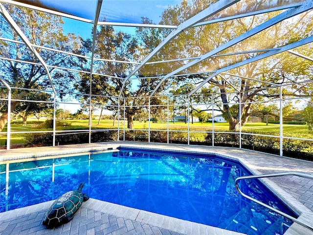 pool with a lanai and a patio area