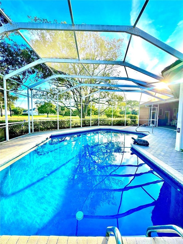 outdoor pool featuring a patio and a lanai