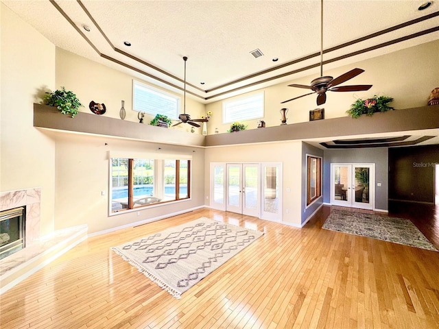 living room with french doors, a fireplace, and hardwood / wood-style flooring