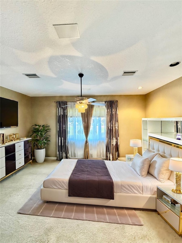 carpeted bedroom with baseboards, visible vents, and a textured ceiling