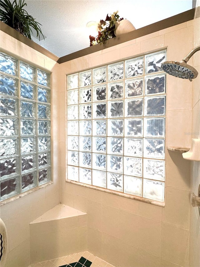 bathroom featuring a textured ceiling and walk in shower