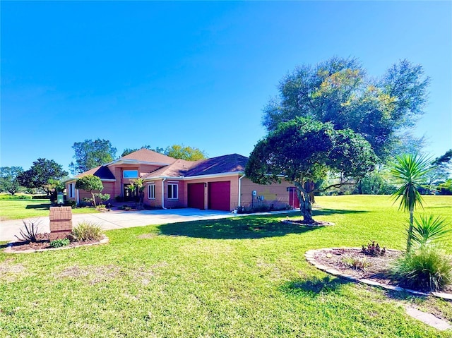 view of yard with an attached garage and concrete driveway