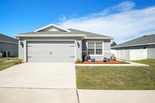 ranch-style house featuring driveway, fence, a front lawn, and stucco siding