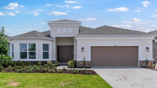 5646 Nevis Ter, Kissimmee, FL 34758 - prairie-style house featuring stucco siding, stone siding, and roof with shingles