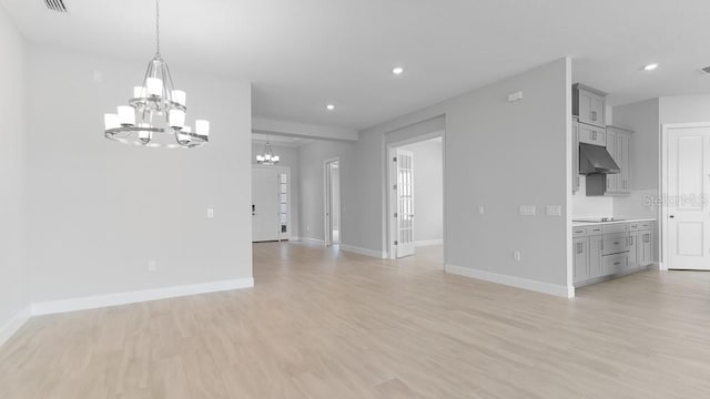 5646 Nevis Ter, Kissimmee, FL 34758 - unfurnished living room featuring a chandelier, baseboards, light wood-style floors, and recessed lighting