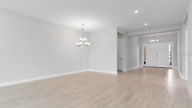 5646 Nevis Ter, Kissimmee, FL 34758 - foyer entrance with a chandelier, baseboards, light wood-type flooring, and recessed lighting